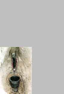 tar is flowing trough the gutter into a bucket